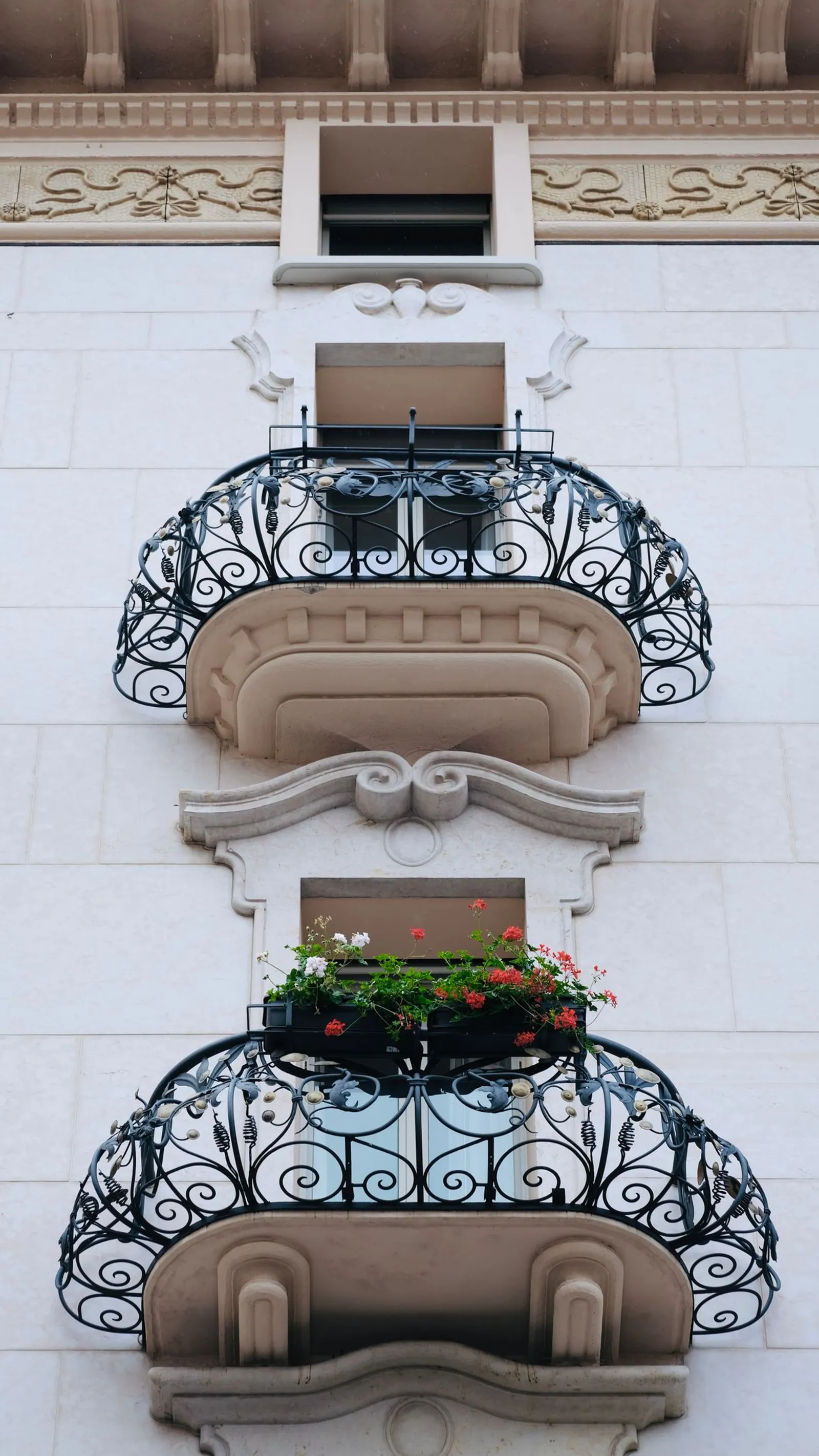 Ornate wrought iron balcony with built-in planter