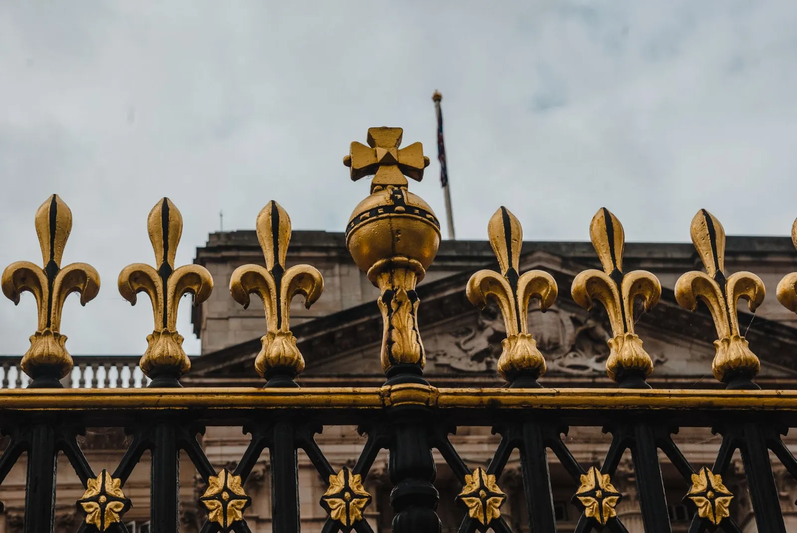 Gilded finials atop an iron gate