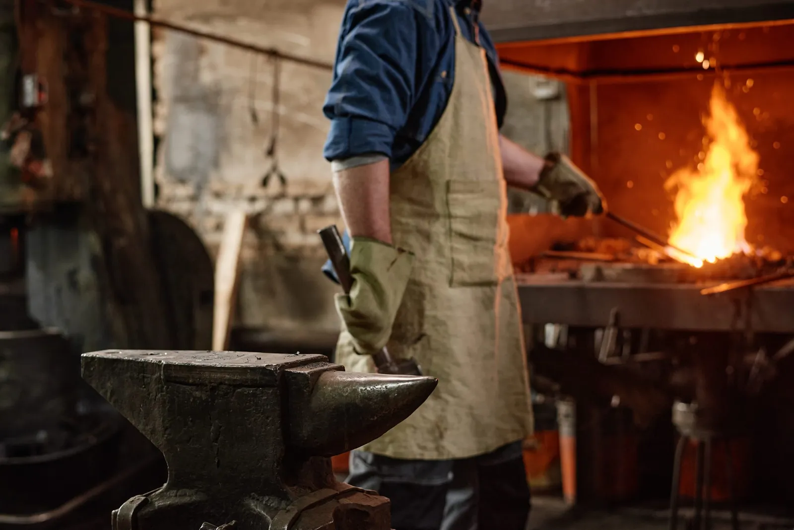 Blacksmith at work by the forge fire