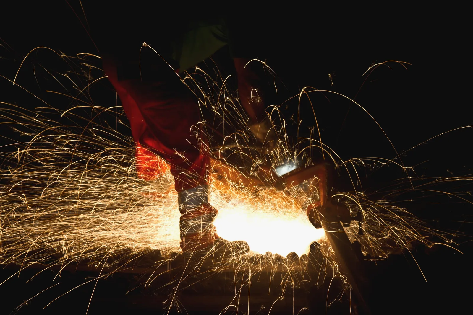 Blacksmith working metal, sparks flying