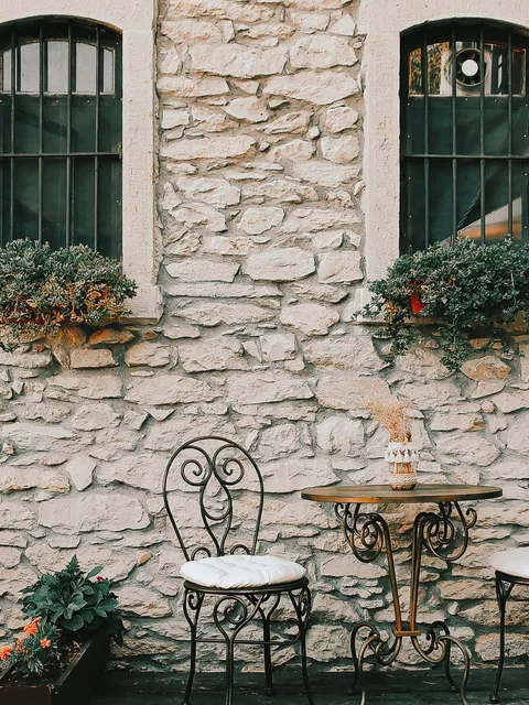 Wrought iron garden furniture on a stone terrace