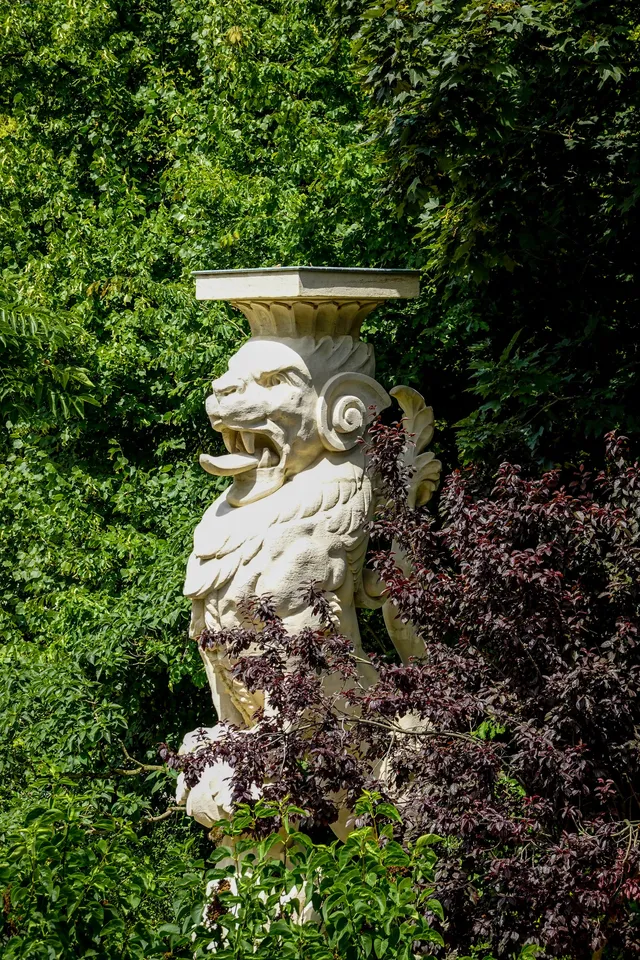 Lion statue in a wooded garden